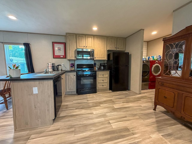 4711 Walnut Rd Unit F2, Buckeye Lake, OH 43008 - kitchen featuring black appliances, washer and dryer, dark countertops, a peninsula, and light wood finished floors