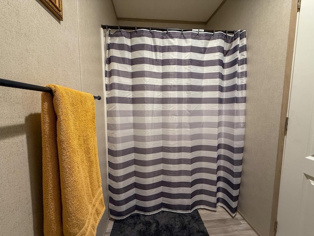 4711 Walnut Rd Unit F2, Buckeye Lake, OH 43008 - bathroom featuring a textured wall, wood finished floors, and a shower with shower curtain