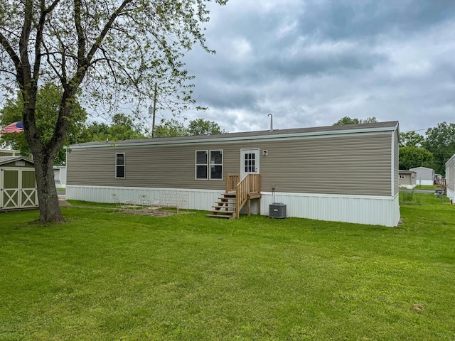 4711 Walnut Rd Unit F2, Buckeye Lake, OH 43008 - back of house with a yard and central AC unit