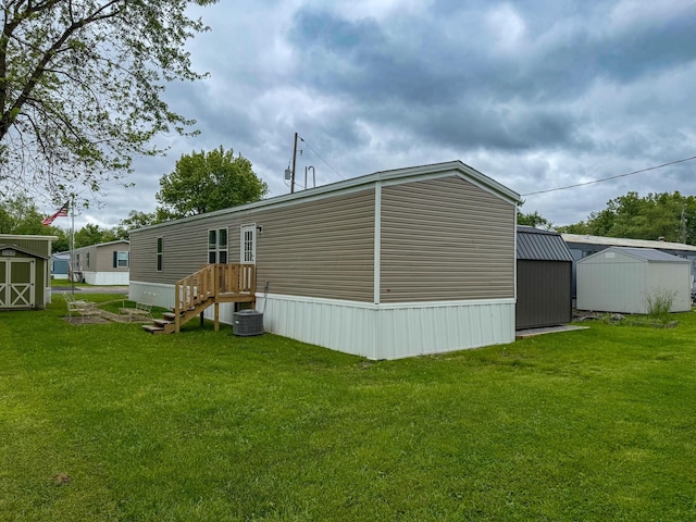 4711 Walnut Rd Unit F2, Buckeye Lake, OH 43008 - rear view of property featuring a yard and central AC unit