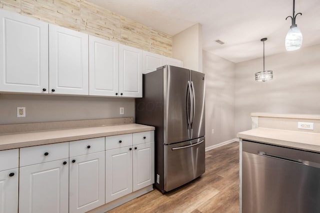 1989 Berrancher Dr, Columbus, OH 43228 - kitchen featuring appliances with stainless steel finishes, white cabinetry, light wood-style flooring, and light countertops