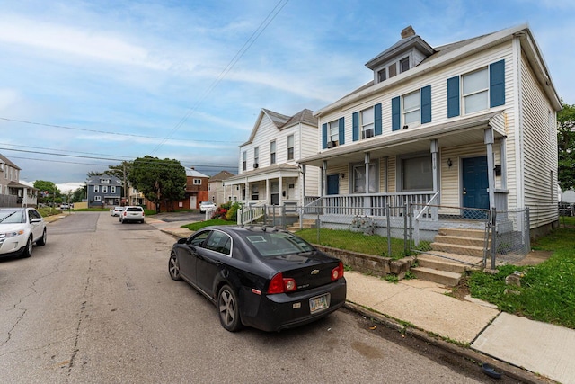 1808 S 6th St, Columbus, OH 43207 - view of property with a porch, a residential view, and a chimney