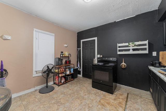 1808 S 6th St, Columbus, OH 43207 - kitchen with electric range, baseboards, dark cabinets, and light countertops