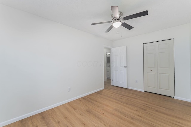1747 E 25th Ave, Columbus, OH 43219 - unfurnished bedroom featuring light wood-style flooring, baseboards, a closet, and ceiling fan