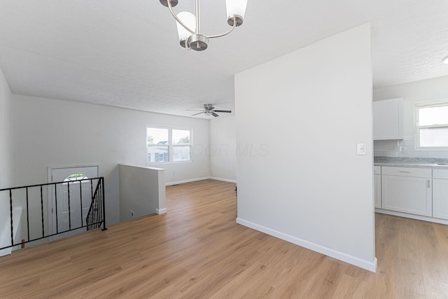 1747 E 25th Ave, Columbus, OH 43219 - empty room featuring light wood-type flooring, baseboards, plenty of natural light, and a ceiling fan