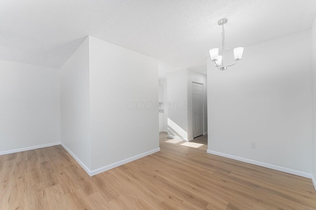 1747 E 25th Ave, Columbus, OH 43219 - additional living space with a chandelier, baseboards, and light wood-style floors