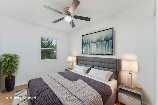 1747 E 25th Ave, Columbus, OH 43219 - bedroom with wood finished floors, baseboards, and a ceiling fan