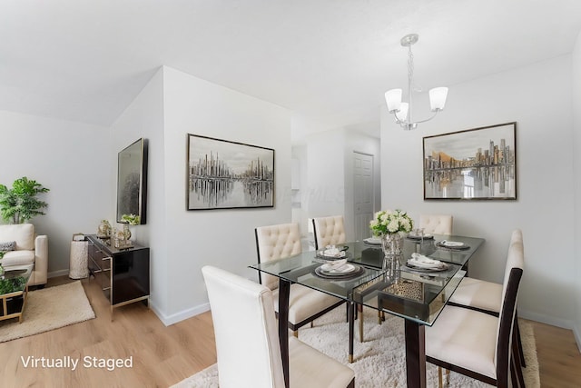 1747 E 25th Ave, Columbus, OH 43219 - dining room with light wood-style flooring, a chandelier, and baseboards