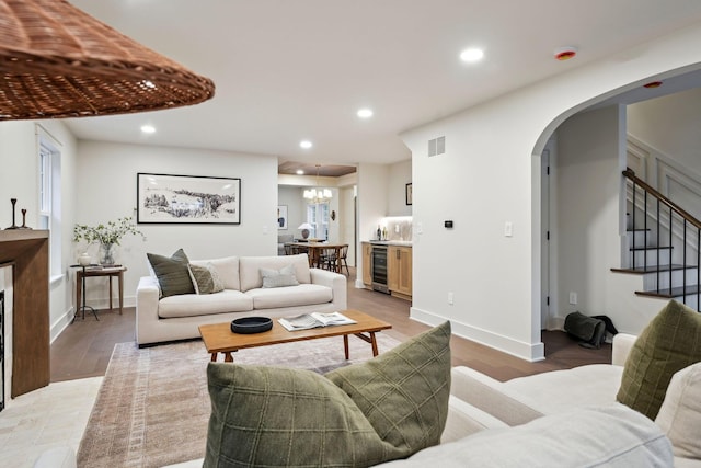 1884 W Lane Ave, Columbus, OH 43221 - living room with beverage cooler, arched walkways, recessed lighting, stairs, and light wood finished floors
