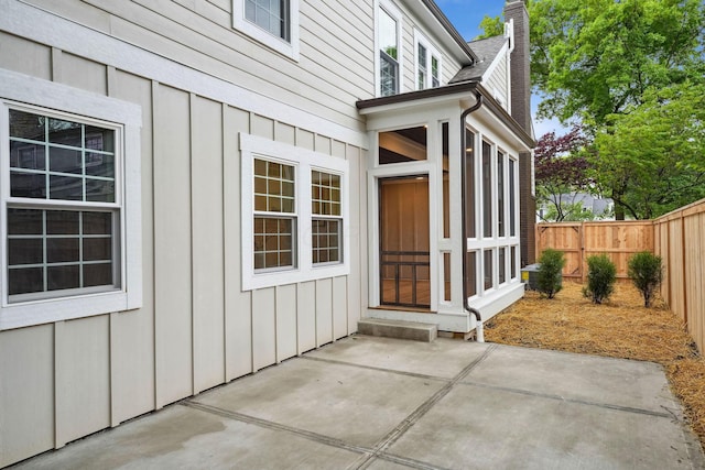 1884 W Lane Ave, Columbus, OH 43221 - property entrance with a chimney, a patio, and board and batten siding