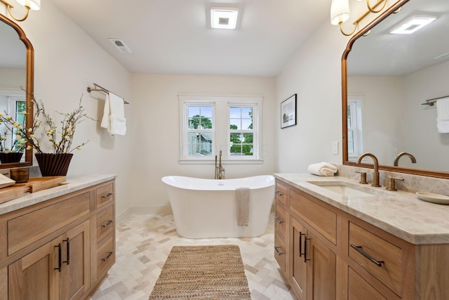 1884 W Lane Ave, Columbus, OH 43221 - full bathroom featuring vanity, a freestanding tub, and tile patterned floors