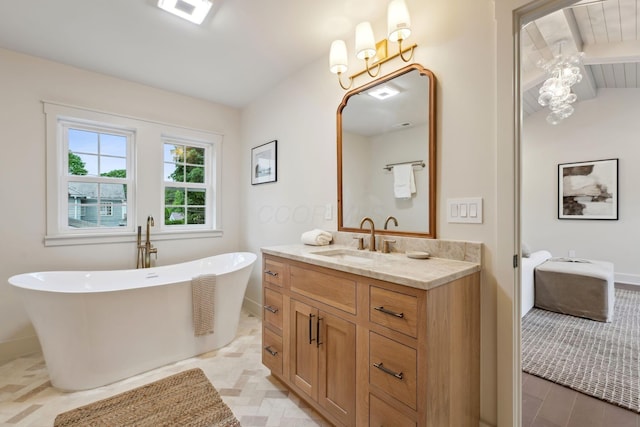 1884 W Lane Ave, Columbus, OH 43221 - bathroom featuring vanity, a soaking tub, and baseboards