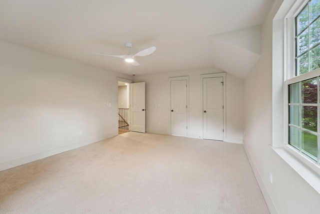 1884 W Lane Ave, Columbus, OH 43221 - unfurnished bedroom featuring carpet, baseboards, ceiling fan, vaulted ceiling, and two closets