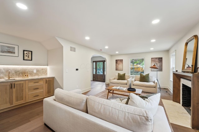 1884 W Lane Ave, Columbus, OH 43221 - living room with arched walkways, a fireplace, recessed lighting, and wood finished floors