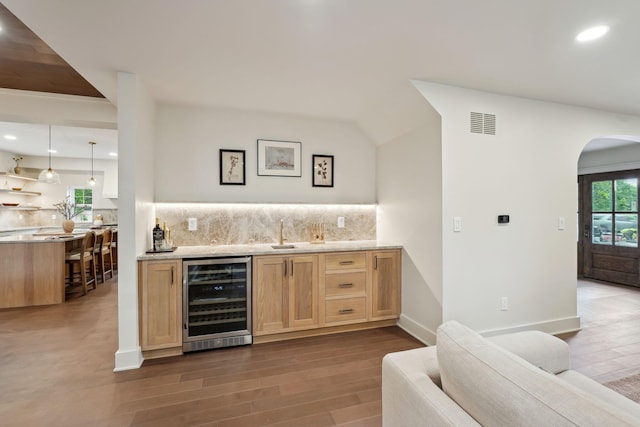 1884 W Lane Ave, Columbus, OH 43221 - indoor wet bar with beverage cooler, backsplash, dark wood-style flooring, recessed lighting, and lofted ceiling