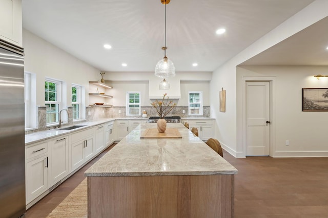1884 W Lane Ave, Columbus, OH 43221 - kitchen featuring a sink, decorative backsplash, a kitchen island, stainless steel built in refrigerator, and light stone counters