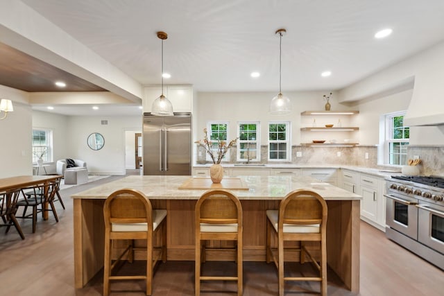 1884 W Lane Ave, Columbus, OH 43221 - kitchen with high quality appliances, white cabinets, light stone countertops, tasteful backsplash, and recessed lighting
