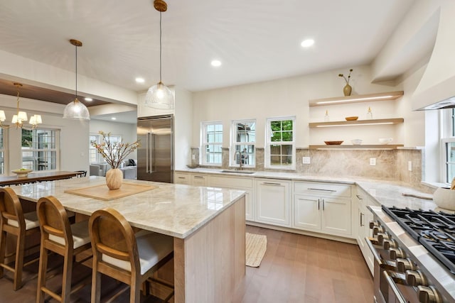 1884 W Lane Ave, Columbus, OH 43221 - kitchen with high quality appliances, light stone countertops, a sink, decorative backsplash, and healthy amount of natural light