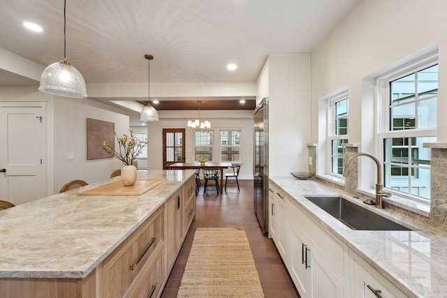 1884 W Lane Ave, Columbus, OH 43221 - kitchen featuring a sink, light stone countertops, a kitchen island, a chandelier, and plenty of natural light