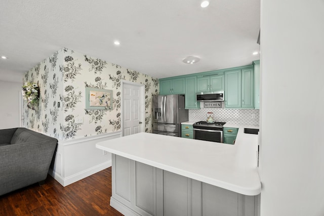 4088 Sweet Shadow Ave, Columbus, OH 43230 - kitchen featuring stainless steel appliances, dark wood finished floors, a peninsula, wainscoting, and green cabinets
