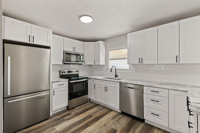 4778 Hafey Ave, Columbus, OH 43228 - kitchen with stainless steel appliances, a textured ceiling, and white cabinetry