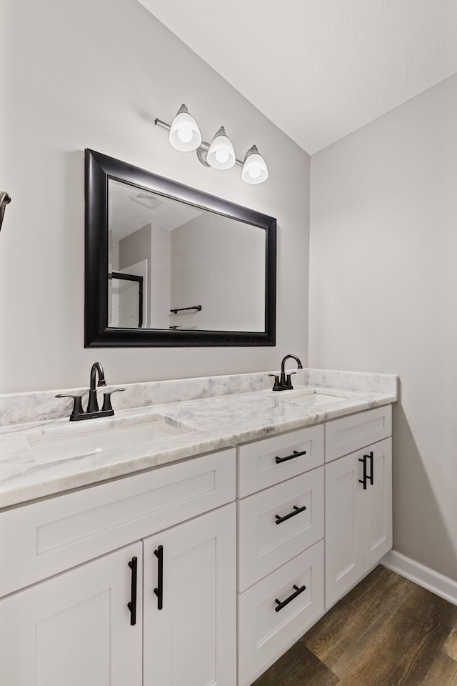 4778 Hafey Ave, Columbus, OH 43228 - full bathroom with double vanity and wood finished floors