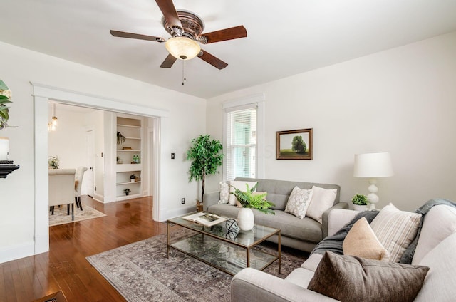 1089 Perry St, Columbus, OH 43201 - living room featuring baseboards, ceiling fan, dark wood finished floors, and built in shelves