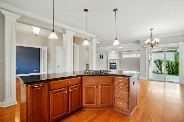 4993 Denbigh Ct, Columbus, OH 43220 - kitchen featuring light wood-type flooring, ornamental molding, pendant lighting, a center island, and a chandelier
