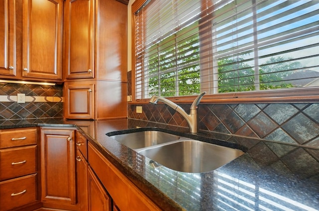 4993 Denbigh Ct, Columbus, OH 43220 - kitchen with brown cabinetry, decorative backsplash, and dark stone countertops