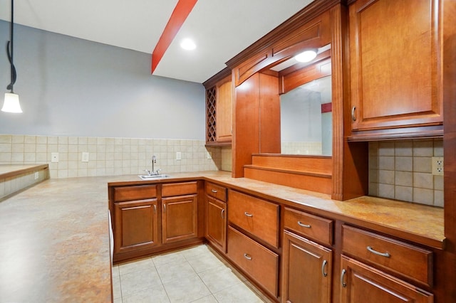 4993 Denbigh Ct, Columbus, OH 43220 - kitchen with light countertops, decorative backsplash, light tile patterned floors, brown cabinets, and recessed lighting