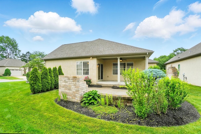 4993 Denbigh Ct, Columbus, OH 43220 - rear view of property with a ceiling fan, stucco siding, a lawn, and a shingled roof
