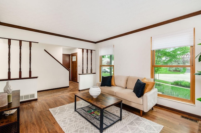 1672 Flat Rock Ct, Columbus, OH 43235 - living area with wood finished floors, baseboards, ornamental molding, and stairway