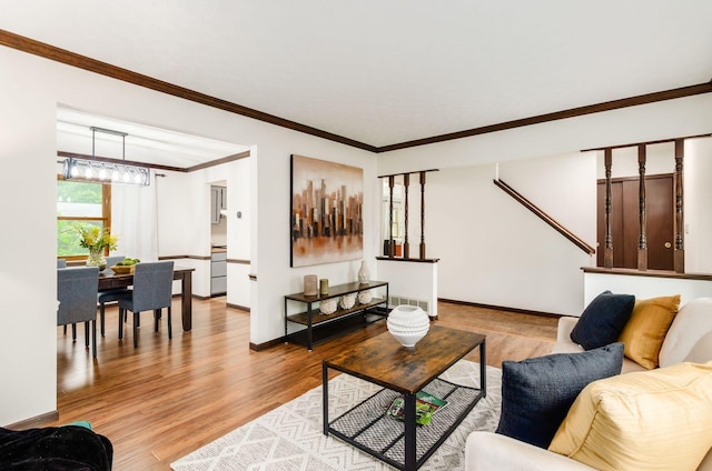 1672 Flat Rock Ct, Columbus, OH 43235 - living room featuring wood finished floors, crown molding, baseboards, and a chandelier