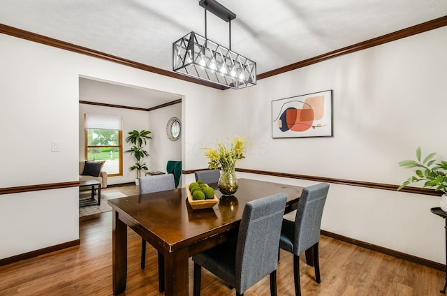 1672 Flat Rock Ct, Columbus, OH 43235 - dining space featuring wood finished floors, baseboards, crown molding, and a chandelier