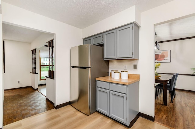 1672 Flat Rock Ct, Columbus, OH 43235 - kitchen featuring freestanding refrigerator, gray cabinets, and baseboards