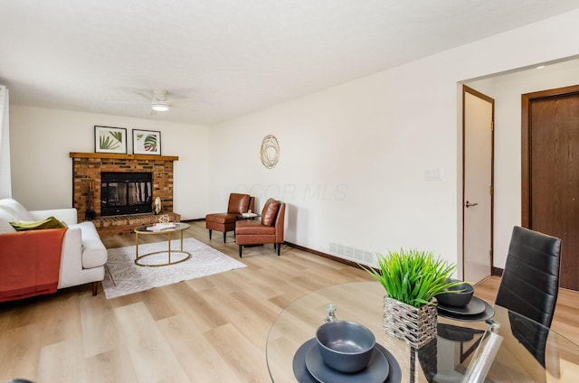 1672 Flat Rock Ct, Columbus, OH 43235 - living area with light wood finished floors, a ceiling fan, and a fireplace