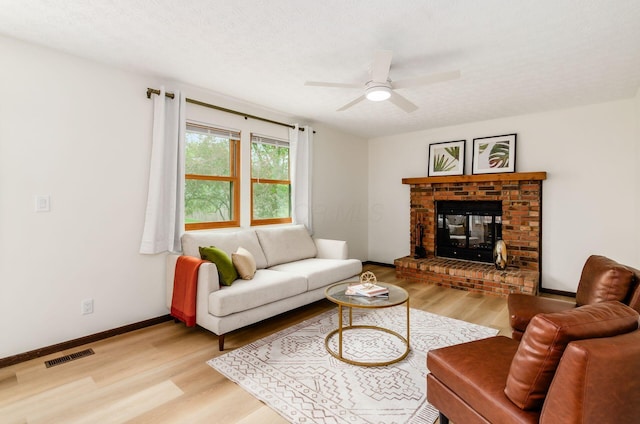 1672 Flat Rock Ct, Columbus, OH 43235 - living room with light wood finished floors, a ceiling fan, a brick fireplace, and baseboards