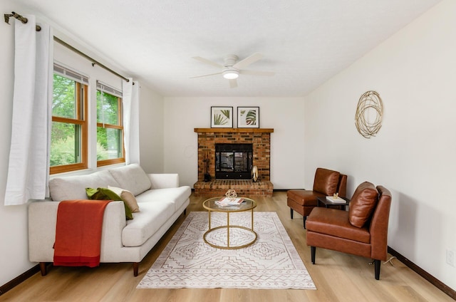 1672 Flat Rock Ct, Columbus, OH 43235 - living area with light wood-style flooring, ceiling fan, a brick fireplace, and baseboards