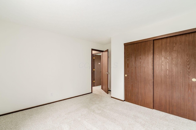 1672 Flat Rock Ct, Columbus, OH 43235 - unfurnished bedroom featuring light colored carpet, a closet, and baseboards