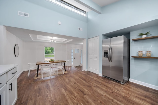 13404 Maple Rd NE, Thornville, OH 43076 - kitchen featuring stainless steel fridge, a tray ceiling, dark wood-style floors, and white cabinetry