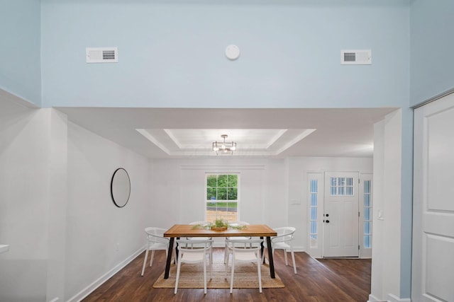 13404 Maple Rd NE, Thornville, OH 43076 - dining area featuring dark wood-type flooring, a raised ceiling, and baseboards