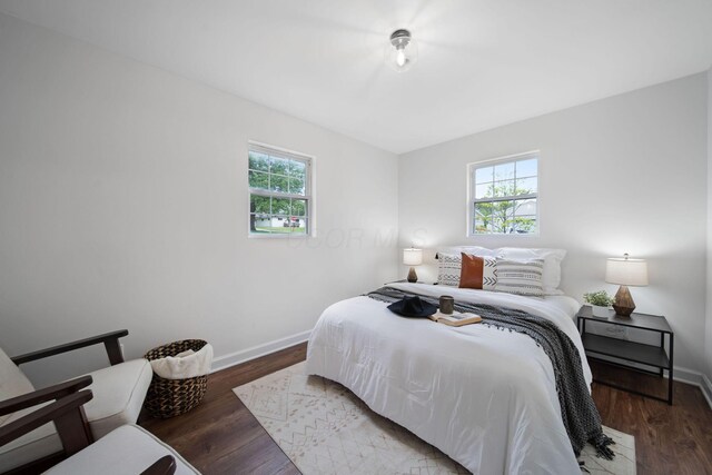 13404 Maple Rd NE, Thornville, OH 43076 - bedroom featuring multiple windows, baseboards, and wood finished floors