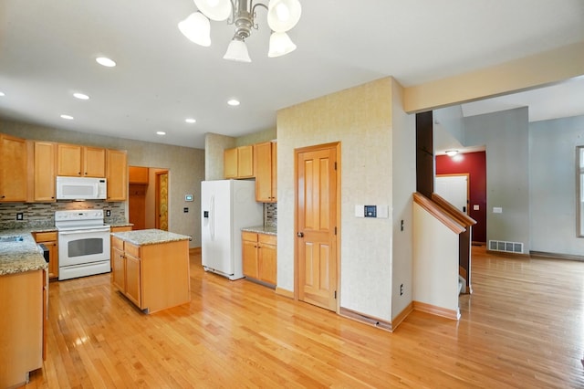 790 Salinger Dr, Lithopolis, OH 43136 - kitchen featuring white appliances, a kitchen island, light wood finished floors, decorative backsplash, and recessed lighting