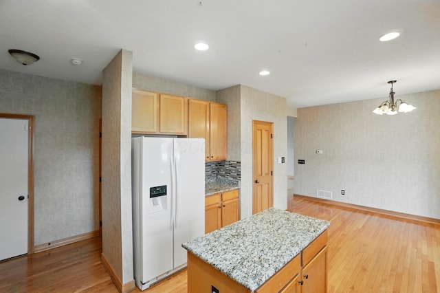790 Salinger Dr, Lithopolis, OH 43136 - kitchen featuring white refrigerator with ice dispenser, light wood finished floors, baseboards, a chandelier, and wallpapered walls