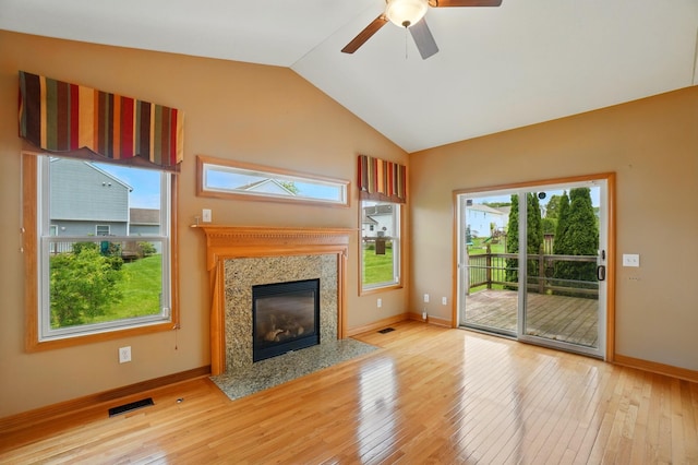 790 Salinger Dr, Lithopolis, OH 43136 - unfurnished living room with light wood-style floors, vaulted ceiling, baseboards, ceiling fan, and a premium fireplace