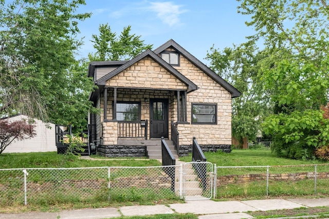 800 Campbell Ave, Columbus, OH 43222 - view of front of house featuring stone siding, covered porch, and a gate