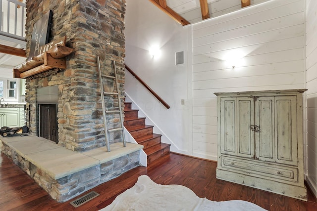 510 Natchez Ln, Sugar Grove, OH 43155 - foyer entrance with wood finished floors, stairs, a stone fireplace, baseboards, and wooden walls