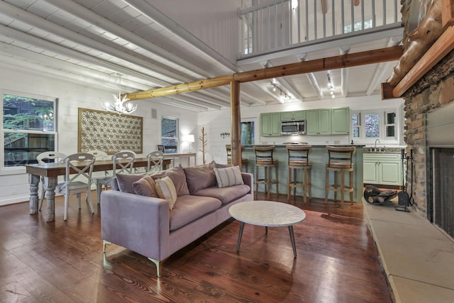 510 Natchez Ln, Sugar Grove, OH 43155 - living area featuring dark wood-type flooring, a chandelier, beam ceiling, a fireplace, and healthy amount of natural light