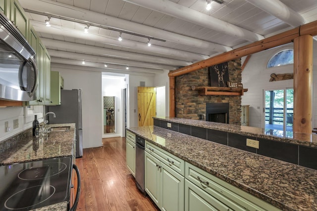 510 Natchez Ln, Sugar Grove, OH 43155 - kitchen with green cabinets, stainless steel microwave, hardwood / wood-style flooring, rail lighting, and beam ceiling