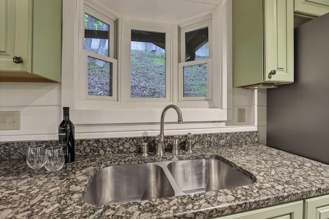 510 Natchez Ln, Sugar Grove, OH 43155 - kitchen view of green cabinetry, a sink, dark stone countertops, and tasteful backsplash